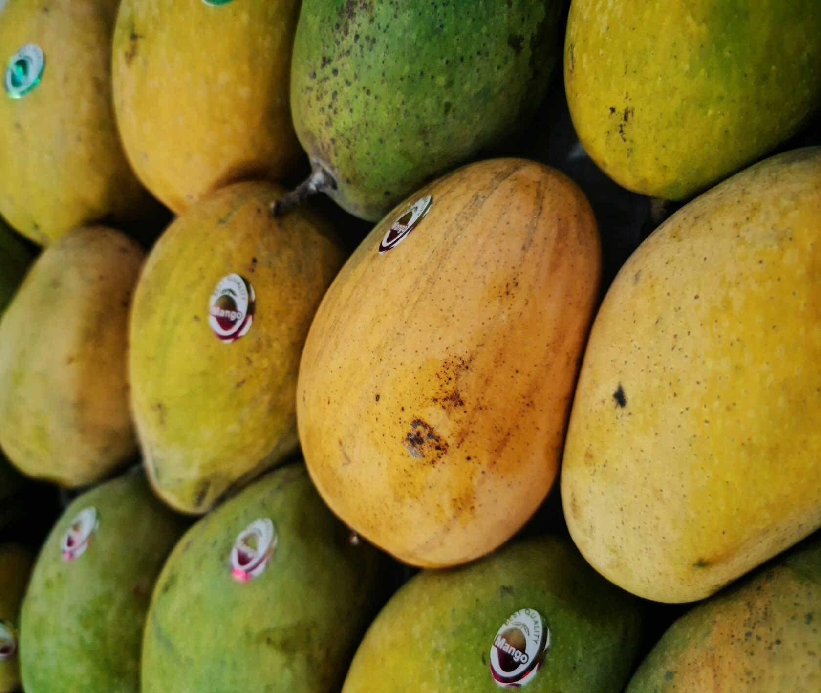 A wooden crate of fresh mango, papaya and oranges packed for delivery.